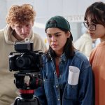 Filming Group of Young Adults Collaborating on Creative Project